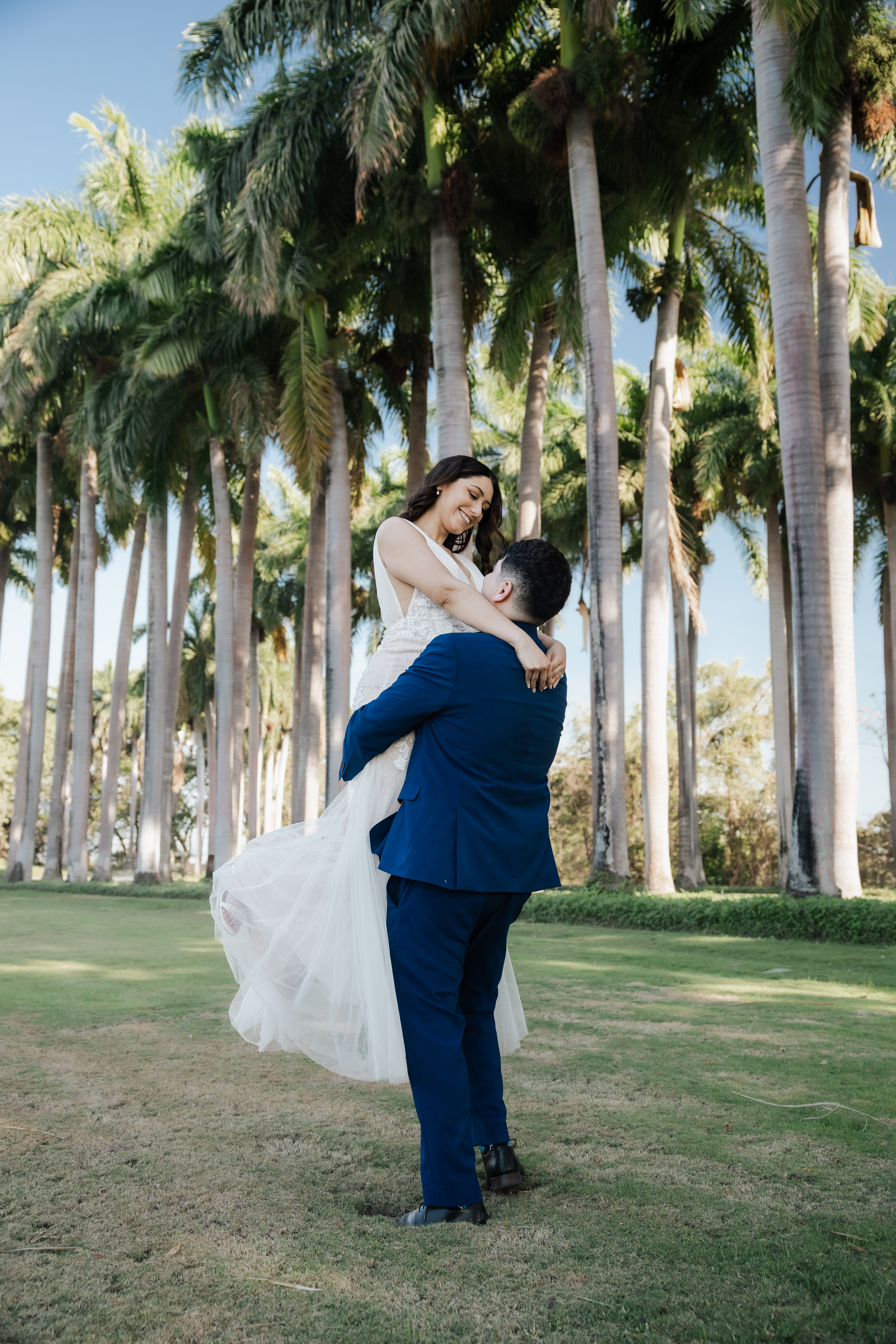Private vows beneath tall palm trees with an ocean view at Andaz Papagayo