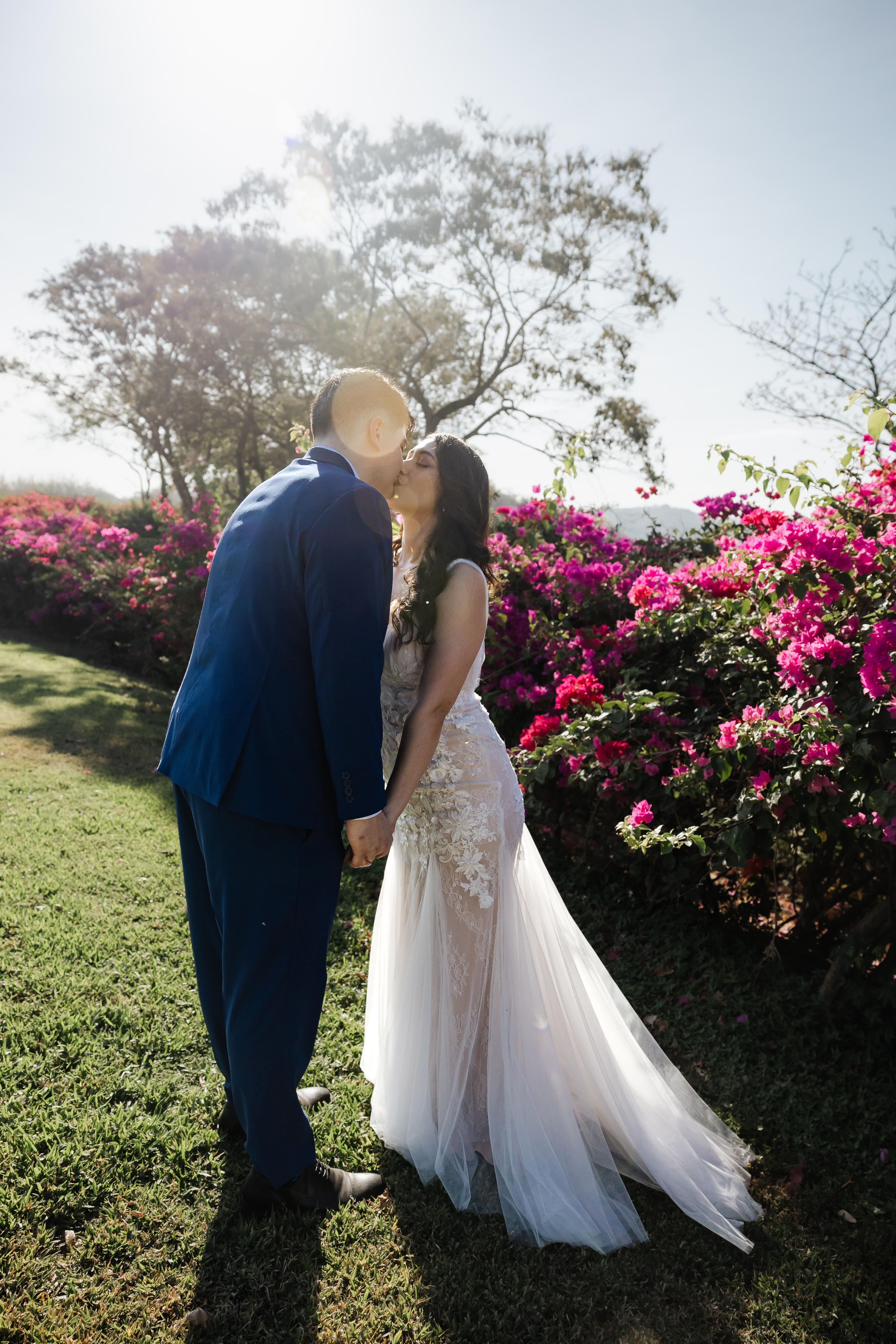 Vows beneath pink bougainvillea at Andaz Papagayo